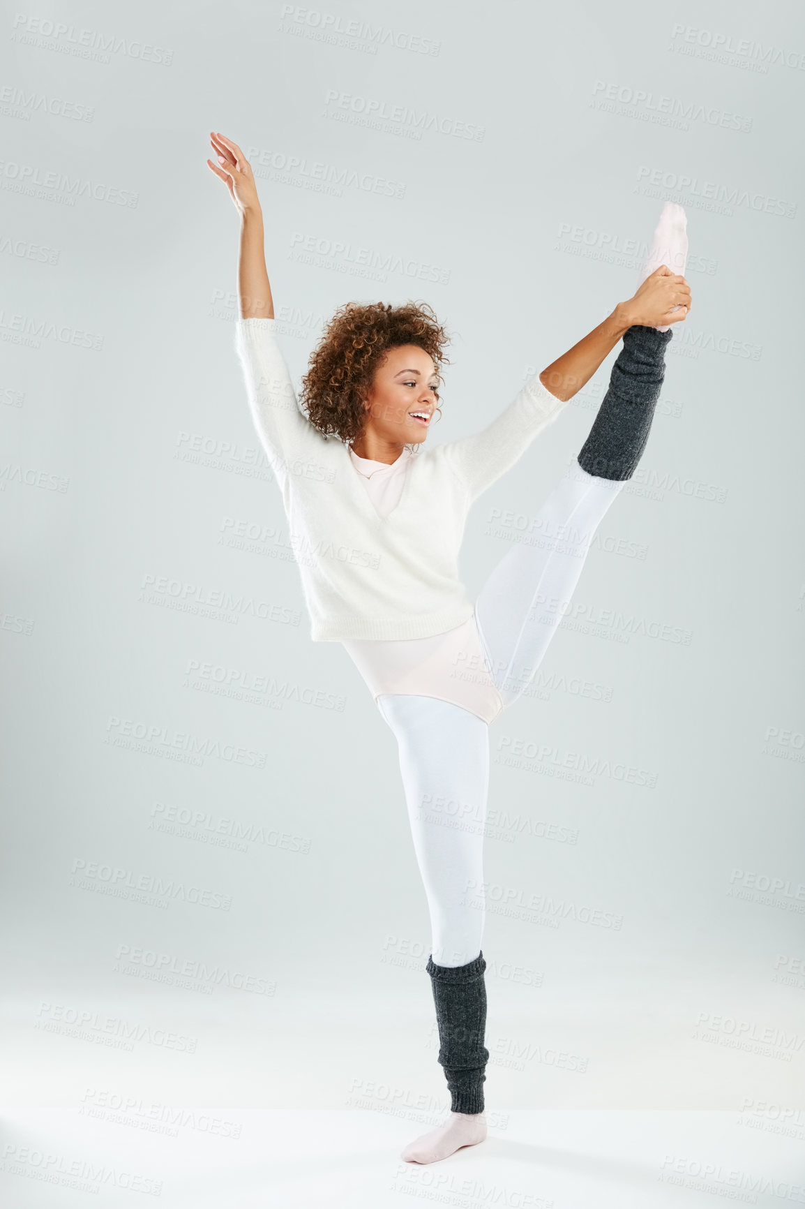 Buy stock photo Studio shot of an attractive young woman dancing against a gray background