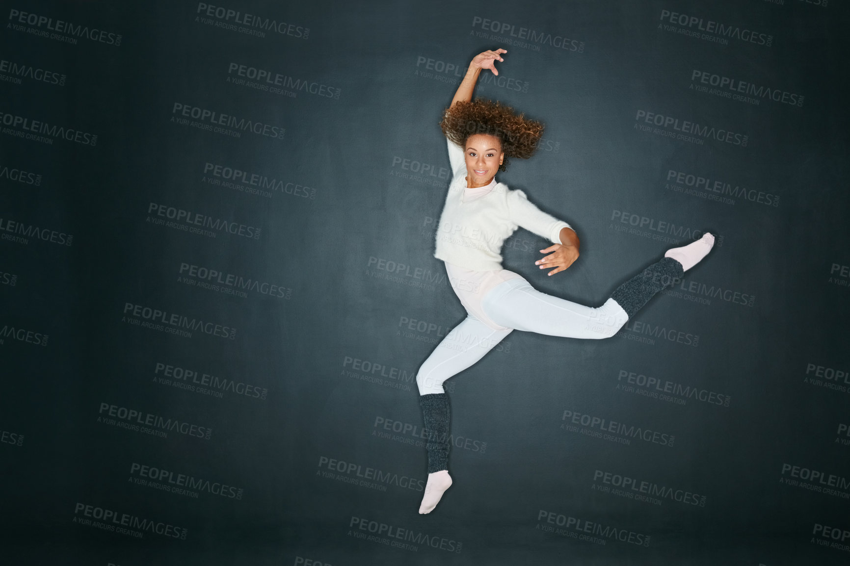 Buy stock photo Studio shot of an attractive young woman dancing against a gray background