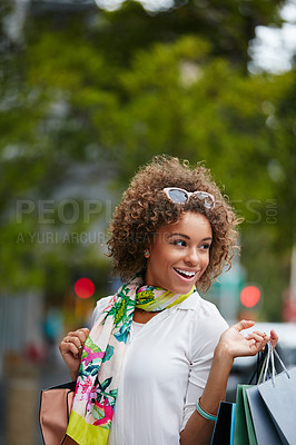 Buy stock photo Shot of an attractive young woman on a shopping spree in the city