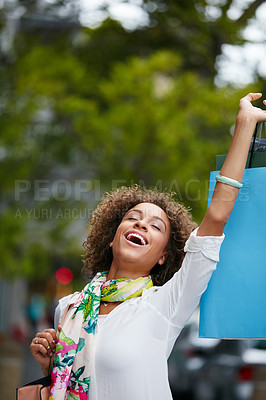 Buy stock photo Shot of an attractive young woman on a shopping spree in the city