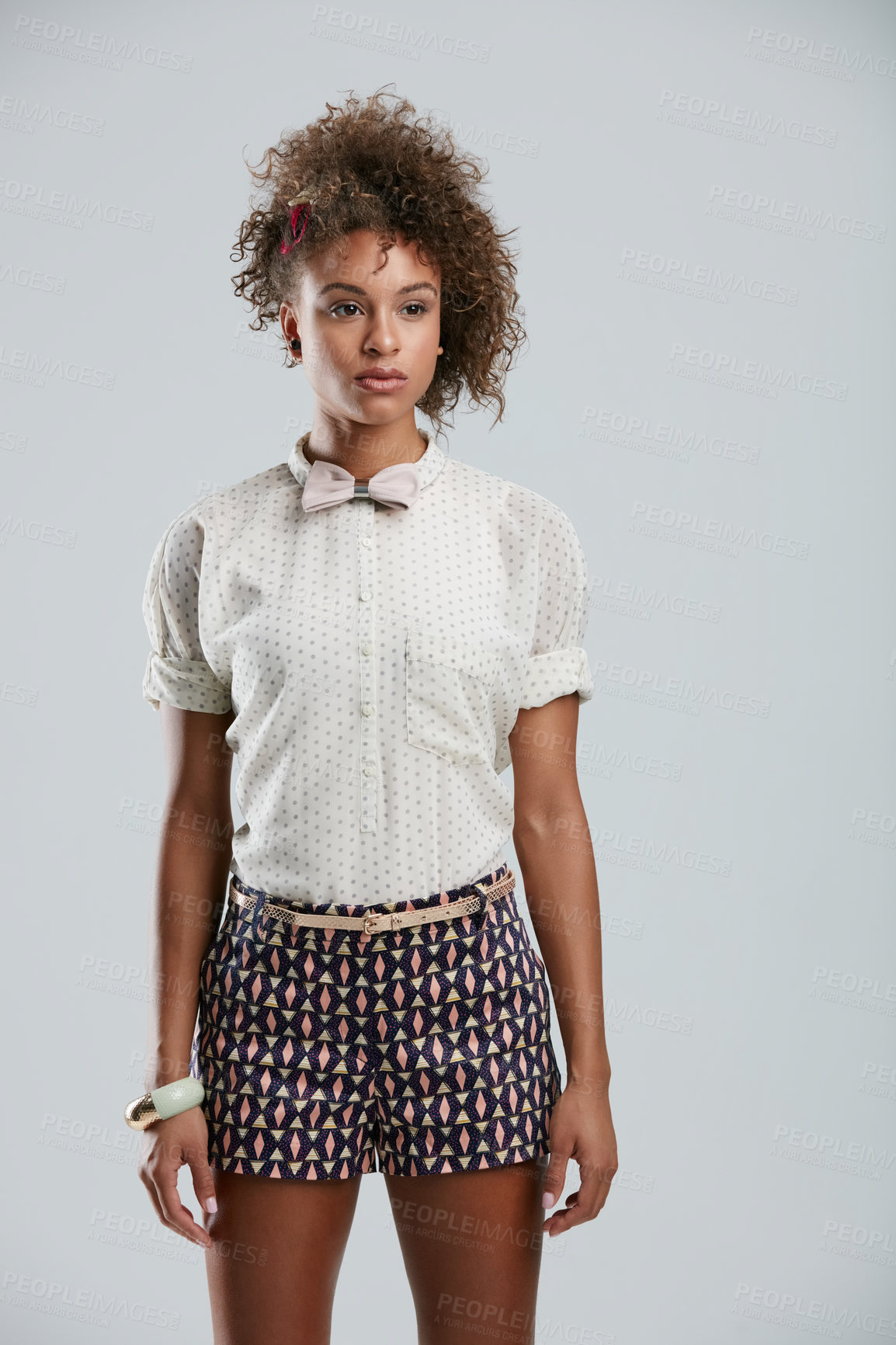 Buy stock photo Fashion, style and clothes with a model black woman in studio on a gray background to promote a clothing brand. Summer, shorts and afro with an attractive young female on space for branding