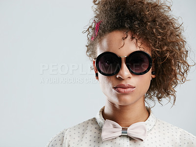 Buy stock photo Black woman, fashion and sunglasses portrait in studio for funky, quirky and trendy people style. Assertive face of fashionista person in isolated gray background for marketing mockup.

