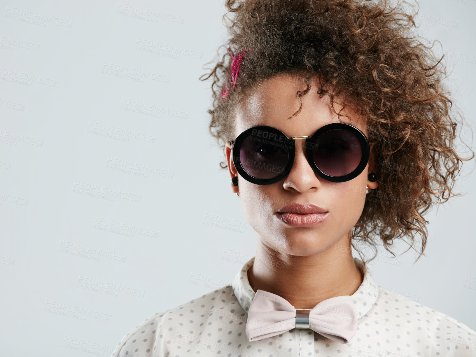 Buy stock photo Black woman, fashion and sunglasses portrait in studio for funky, quirky and trendy people style. Assertive face of fashionista person in isolated gray background for marketing mockup.

