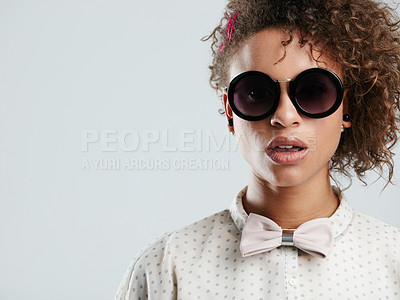 Buy stock photo African woman, fashion sunglasses and studio headshot for makeup, beauty or curly hair afro by gray background. Black woman, dark glasses and edgy portrait for bow tie, trendy aesthetic and confident