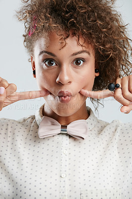 Buy stock photo Silly, goofy and portrait of woman in studio with fingers in her cheeks for funny face expression. Fashion, funky and female model with a edgy and stylish bow tie outfit isolated by white background.