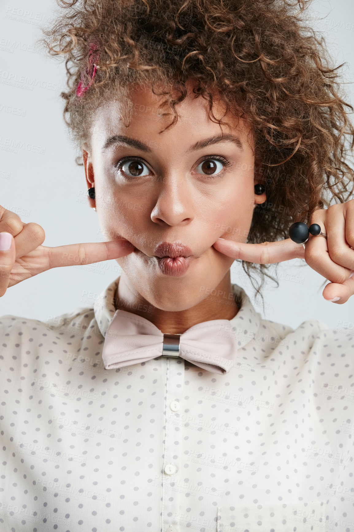 Buy stock photo Silly, goofy and portrait of woman in studio with fingers in her cheeks for funny face expression. Fashion, funky and female model with a edgy and stylish bow tie outfit isolated by white background.