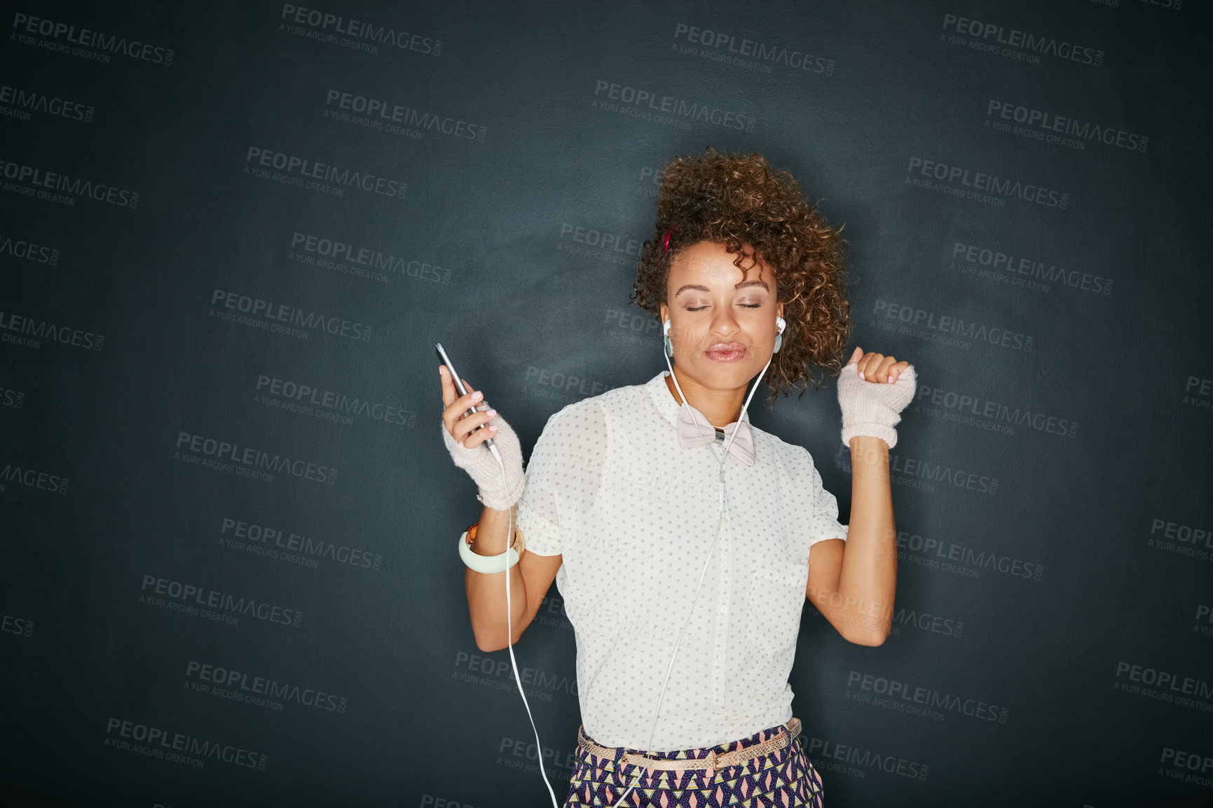 Buy stock photo Phone, dance music and mock up black woman listening to music, audio podcast or radio sound for energy, relief or fun. Studio mockup, dancing girl and retro student isolated on dark background 