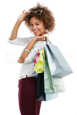 Buy stock photo Studio portrait of an attractive young woman holding shopping bags against a white background