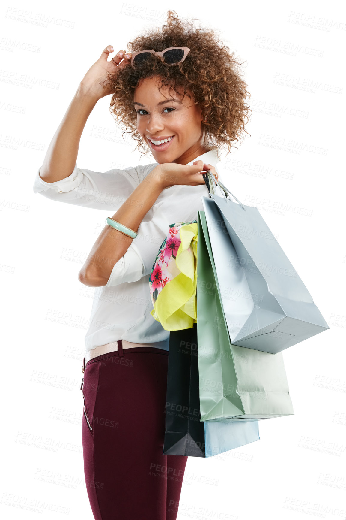 Buy stock photo Studio portrait of an attractive young woman holding shopping bags against a white background