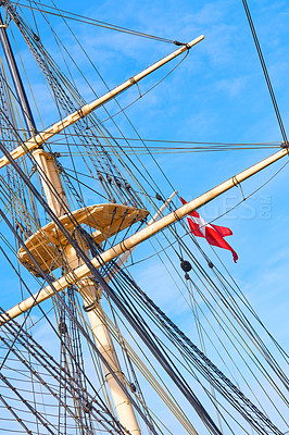 Buy stock photo Blue sky, flag and travel with mast of ship outdoor in nature from below for Danish heritage. Adventure, history and rope with banner on wooden sail boat for journey, holiday or vacation at sea