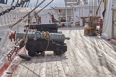 Buy stock photo Museum, boat or cannon on deck in vessel for sightseeing, tourist attraction or national treasure in Denmark. History, architecture or ship with war weapon for landmark, ocean transport or exhibition