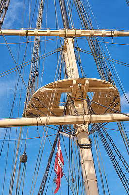 Buy stock photo Blue sky, flag and travel with mast of ship outdoor in nature from below for culture or heritage. Adventure, engineering and rope with banner of Denmark on sail boat for holiday or vacation at sea