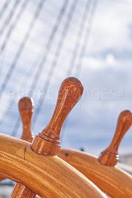 Buy stock photo Sky, ship and wood steering wheel at harbor for sailing, transportation and travel. Ocean, marine and sailboat in closeup for luxury, adventure and trip or journey with cruising and navigation