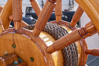 Buy stock photo Wood, old boat and steering wheel for sailing, travel and navigation or control direction with rope closeup. Ship, vintage helm and transport for cruise, history or tourism voyage for journey on deck