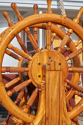 Buy stock photo Wood, ship and vintage steering wheel for sailing, travel and navigation or control direction. Boat, helm and old transport for cruise, history and voyage for journey on deck for vacation or tourism