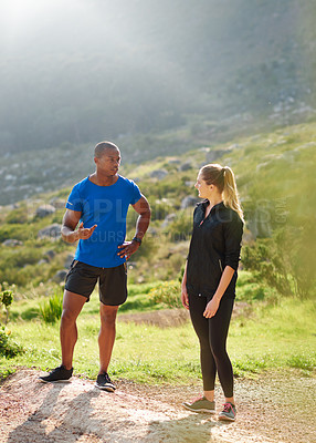 Buy stock photo Shot of two athletes chatting before their run