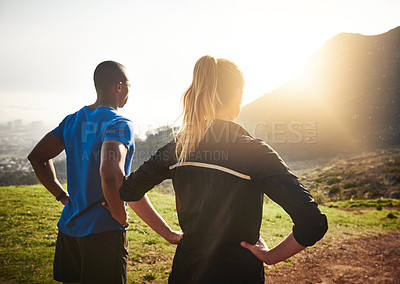 Buy stock photo Rearview shot of two athletes admiring the mountain view