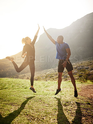 Buy stock photo Shot of a sporty couple high-fiving after a run