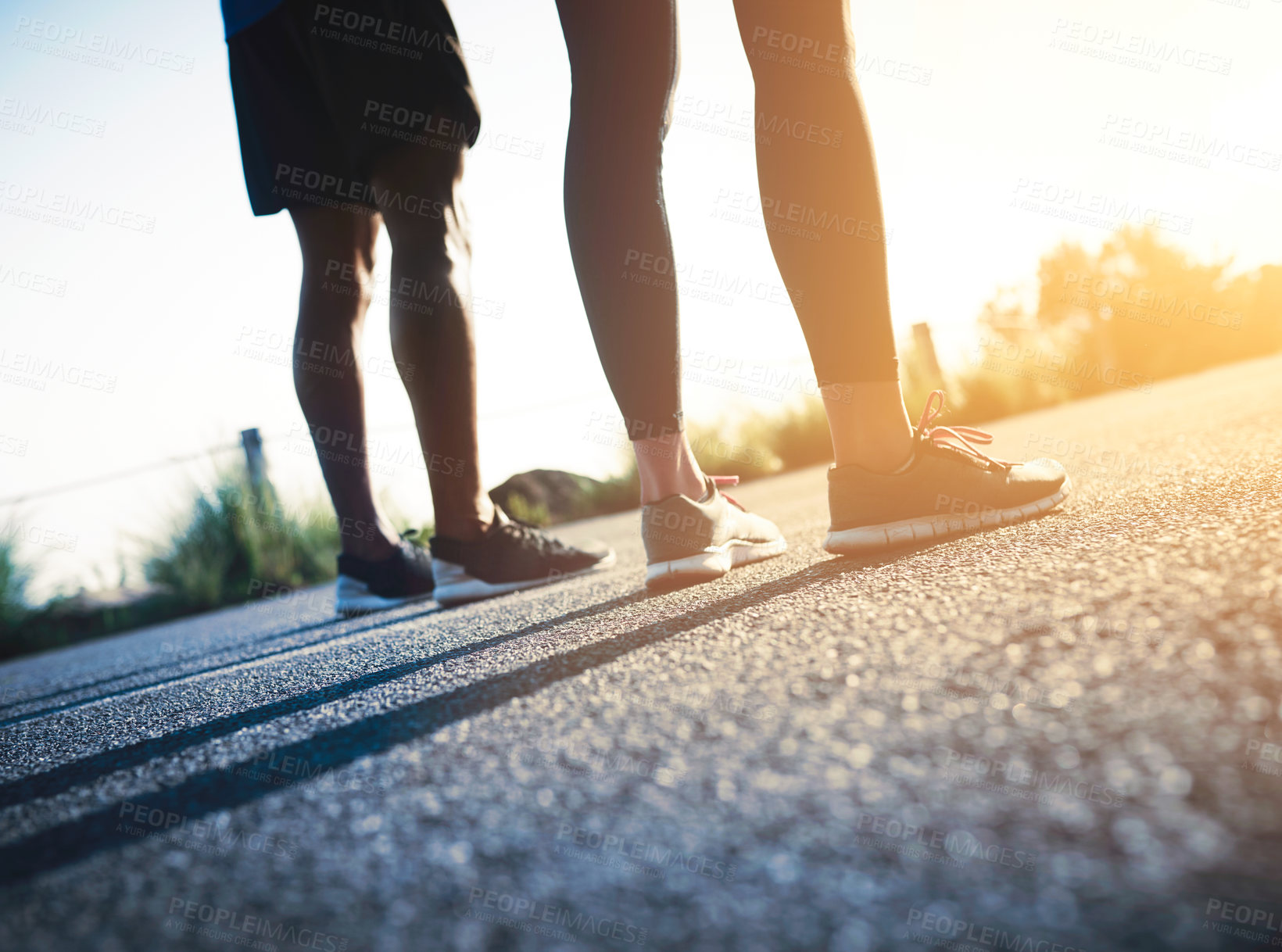 Buy stock photo Cropped shot of two unrecognizable people standing on a tarmac road
