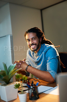 Buy stock photo Portrait of a young designer working late in an office