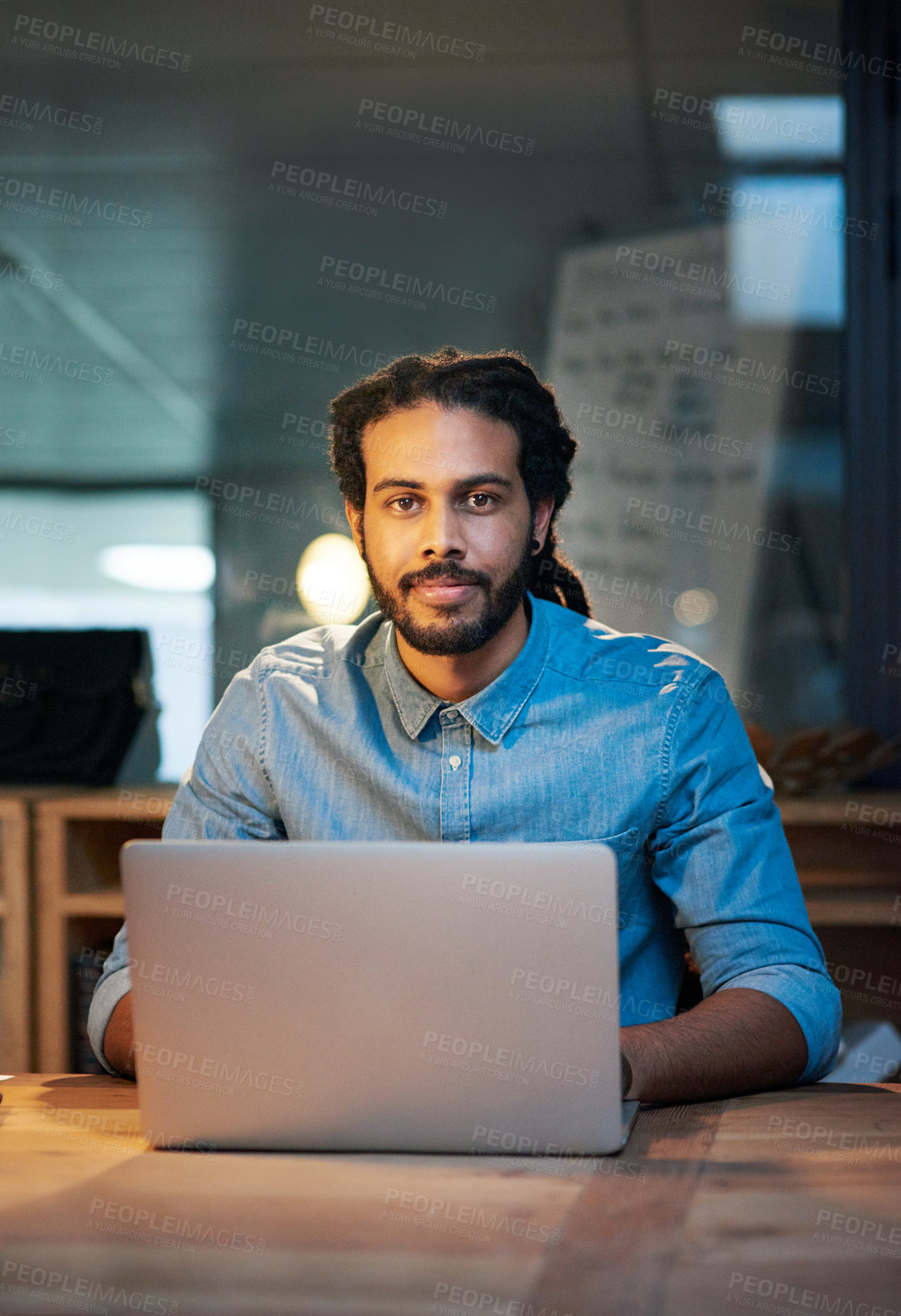 Buy stock photo Portrait of a young designer working late in an office