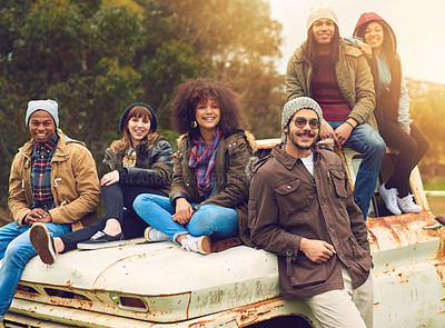 Buy stock photo Portrait of a group of friends posed around an old truck in a field