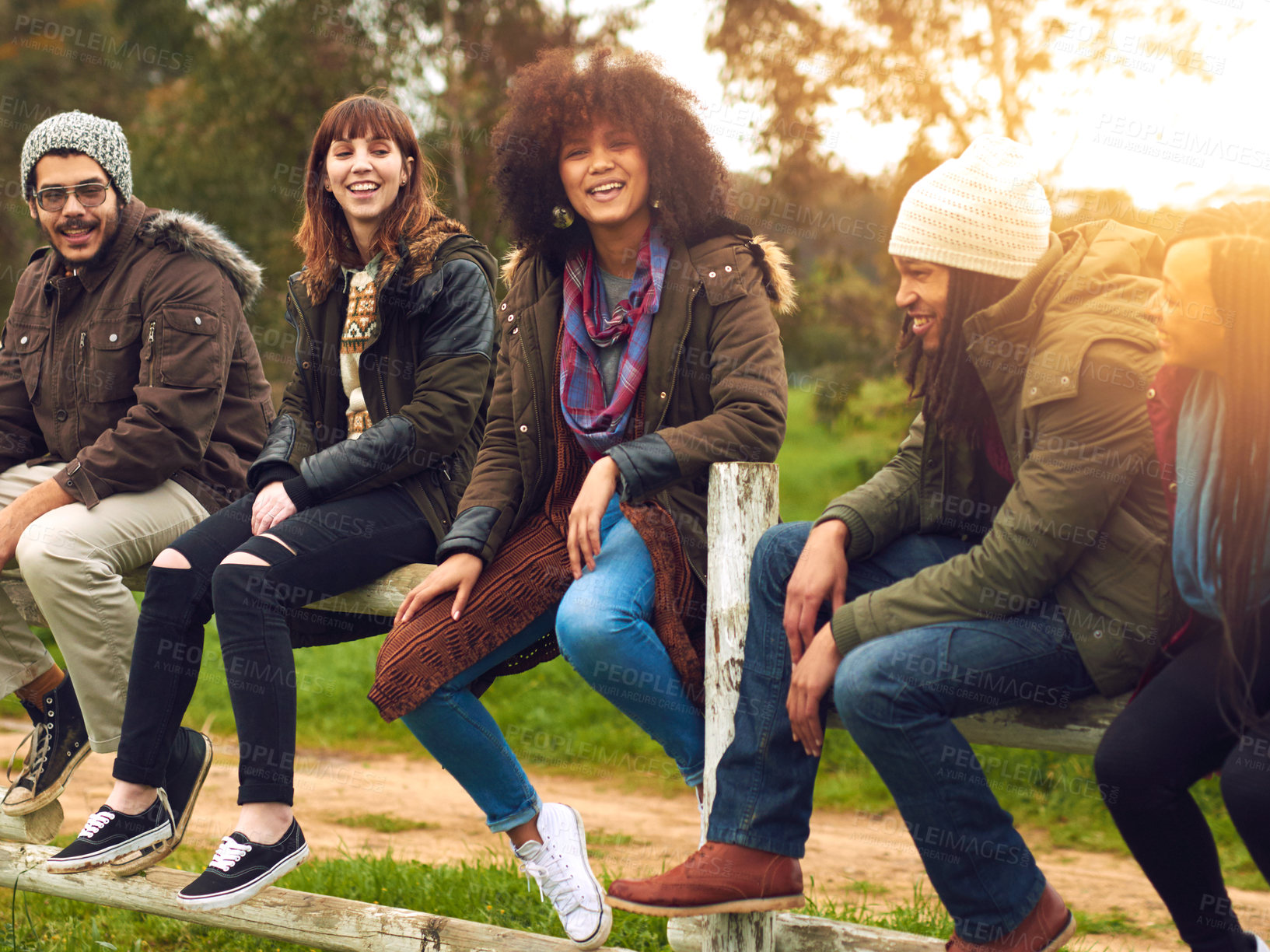 Buy stock photo People, happy and outdoor on fence for travel, social gathering and relationship development. Friends, laugh and talking in nature for storytelling, diversity group or students bonding on study break