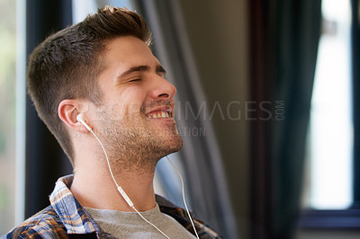 Buy stock photo Man, earphones and happy with music for relax in home with radio, podcast or streaming audio for wellness. Person, smile and peaceful in living room with track, sound and comfortable with eyes closed