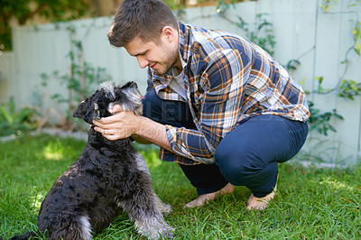 Buy stock photo Shot of a man playing with his dog outside