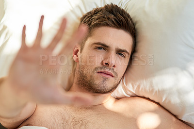 Buy stock photo Man, portrait and bed with hand stop in home for tired wake up or early morning, annoyed or pillow. Male person, face and palm for insomnia problem for lazy weekend or unhappy, grumpy or hungover