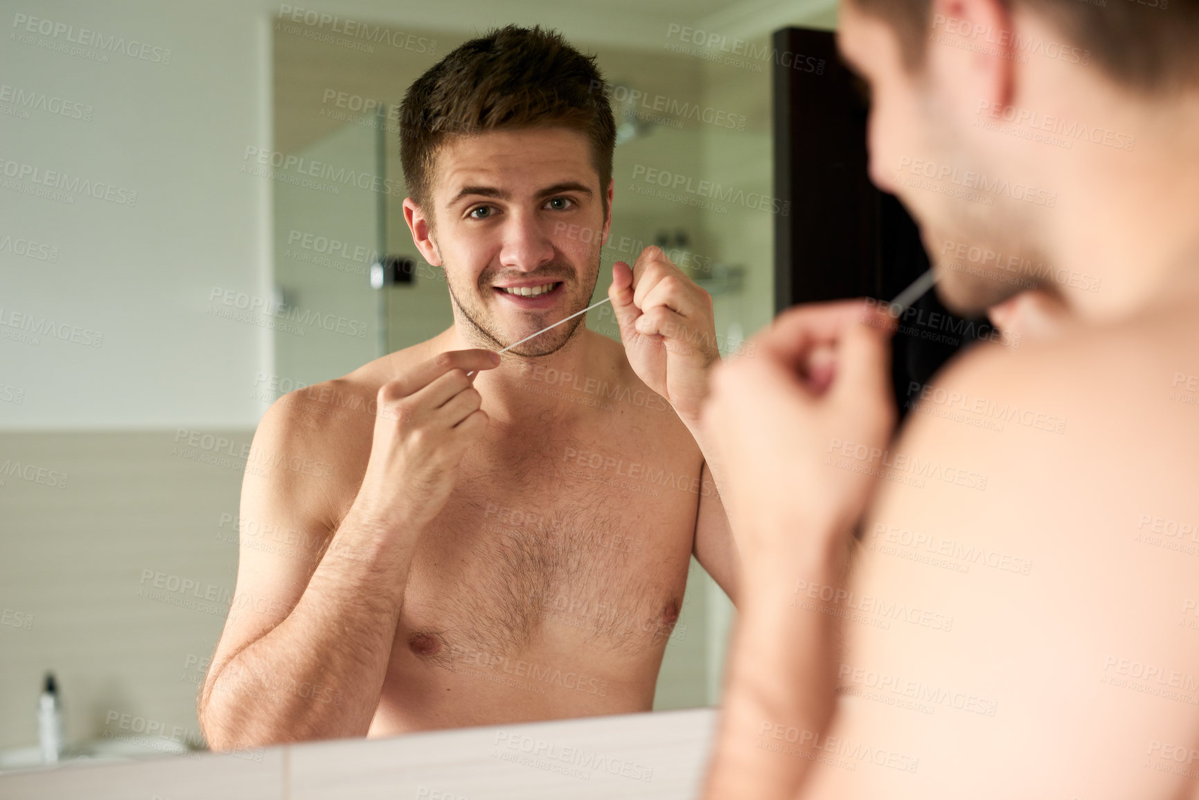 Buy stock photo Man, mirror and floss in morning for dental health in bathroom with cleaning in portrait. House, reflection and oral care for fresh breath with white teeth, grooming and daily routine in Canada.