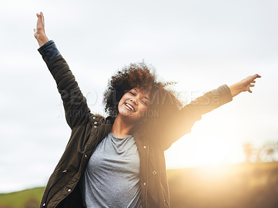 Buy stock photo Portrait of a joyful young woman raising her hands in nature