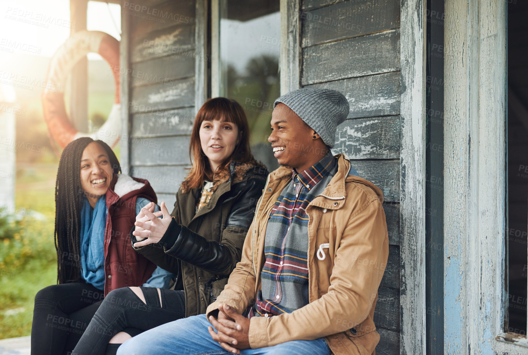 Buy stock photo Winter, group and friends at outdoor cabin with smile, holiday adventure and bonding on lake house porch. Nature, fun and happy people relax on cottage patio in woods for travel vacation together