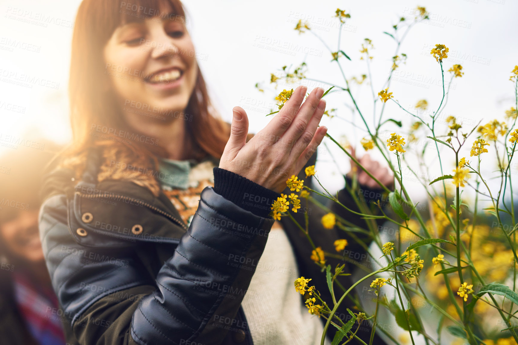 Buy stock photo Flowers, happy and woman in nature on travel, vacation or holiday in countryside for calm and peace. Smile, bloom and female person with floral plants outdoor in field, park or garden on weekend trip