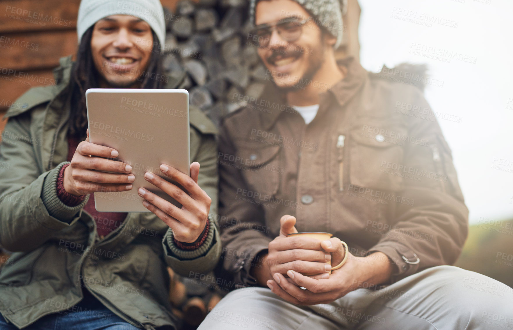 Buy stock photo Happy men, friends and camping with tablet in nature for connectivity, signal or browsing on patio. Male person, relax or campers with technology for entertainment at holiday house in countryside