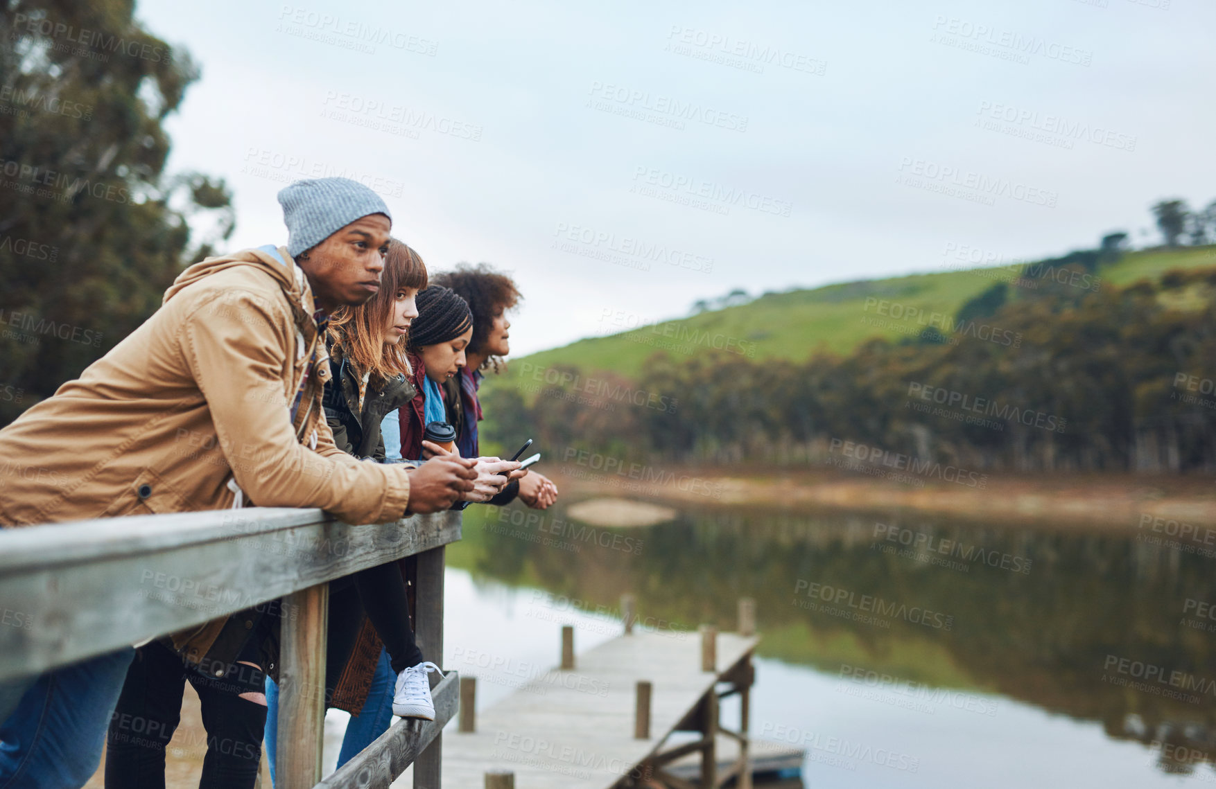 Buy stock photo People, phone or connectivity at lake for travel, social media or blog on adventure in countryside. Friends, tech or relax on river pier for journey break, navigation or research environment for camp