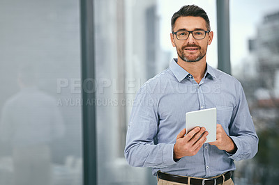 Buy stock photo Portrait of a mature businessman using a digital tablet in an office