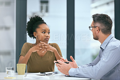 Buy stock photo Cropped shot of two colleagues having a meeting in an office