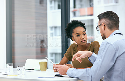 Buy stock photo Cropped shot of two colleagues working together on a digital tablet in an office