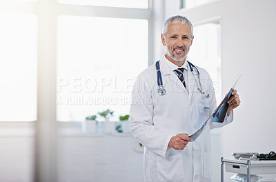 Buy stock photo Portrait of a mature doctor holding an x-ray in a hospital