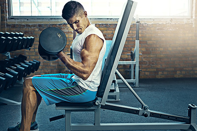 Buy stock photo Shot of a man doing a upper-body workout at the gym