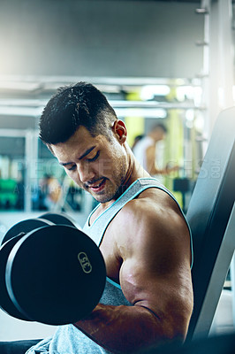 Buy stock photo Shot of a man doing a upper-body workout at the gym