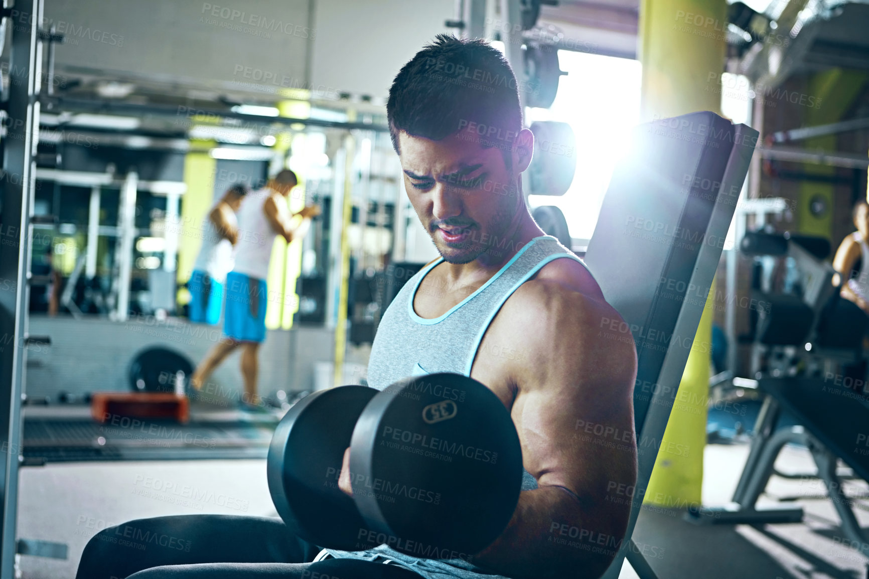 Buy stock photo Shot of a man doing a upper-body workout at the gym