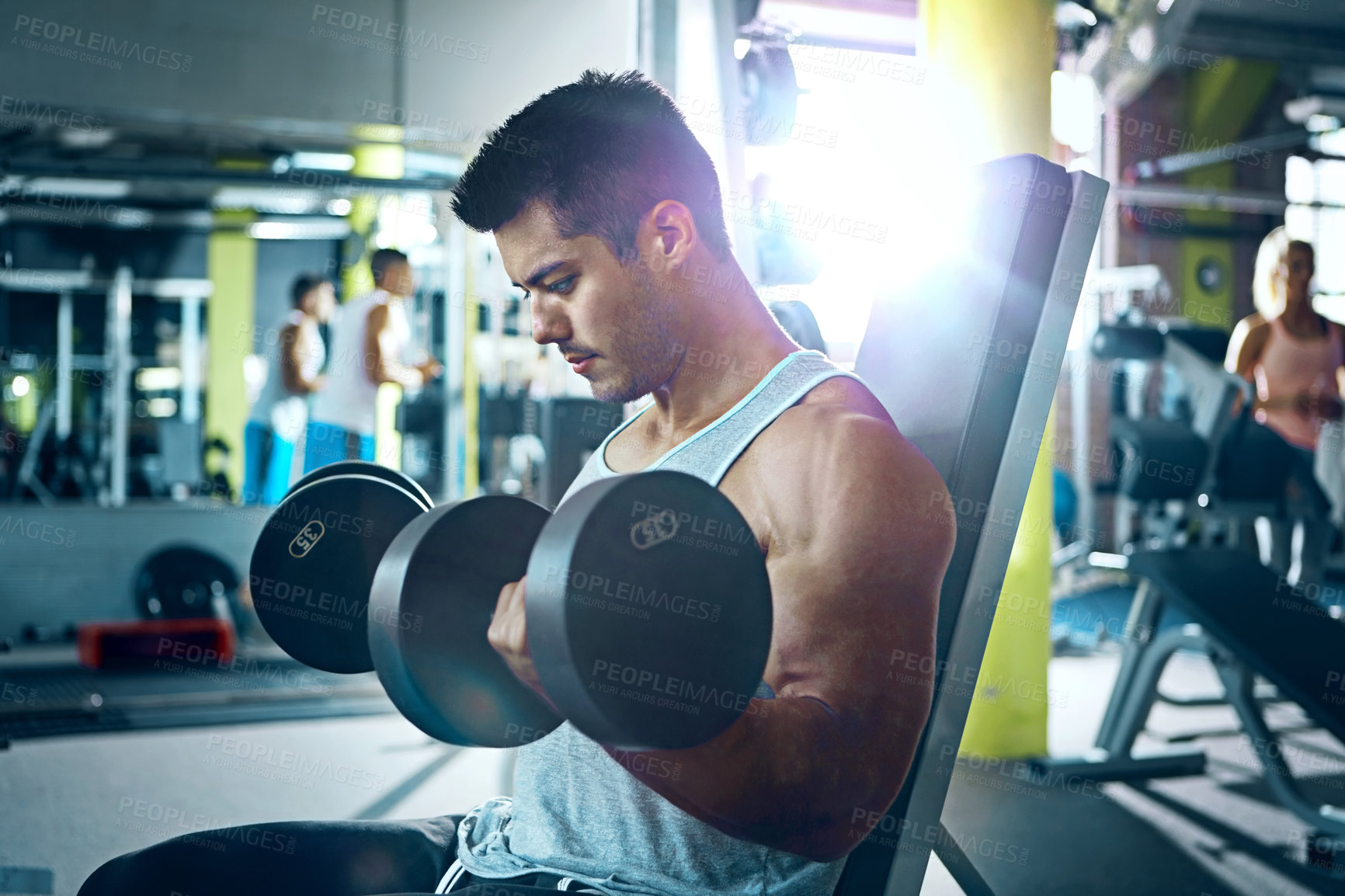 Buy stock photo Shot of a man doing a upper-body workout at the gym