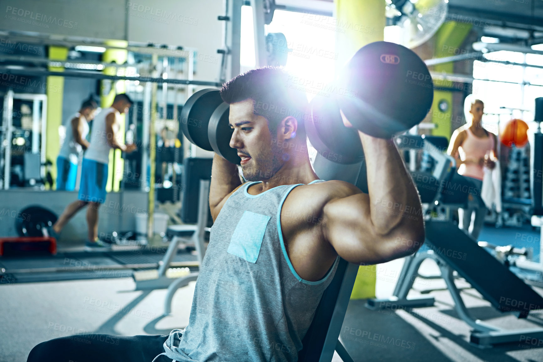 Buy stock photo Shot of a man doing a upper-body workout at the gym