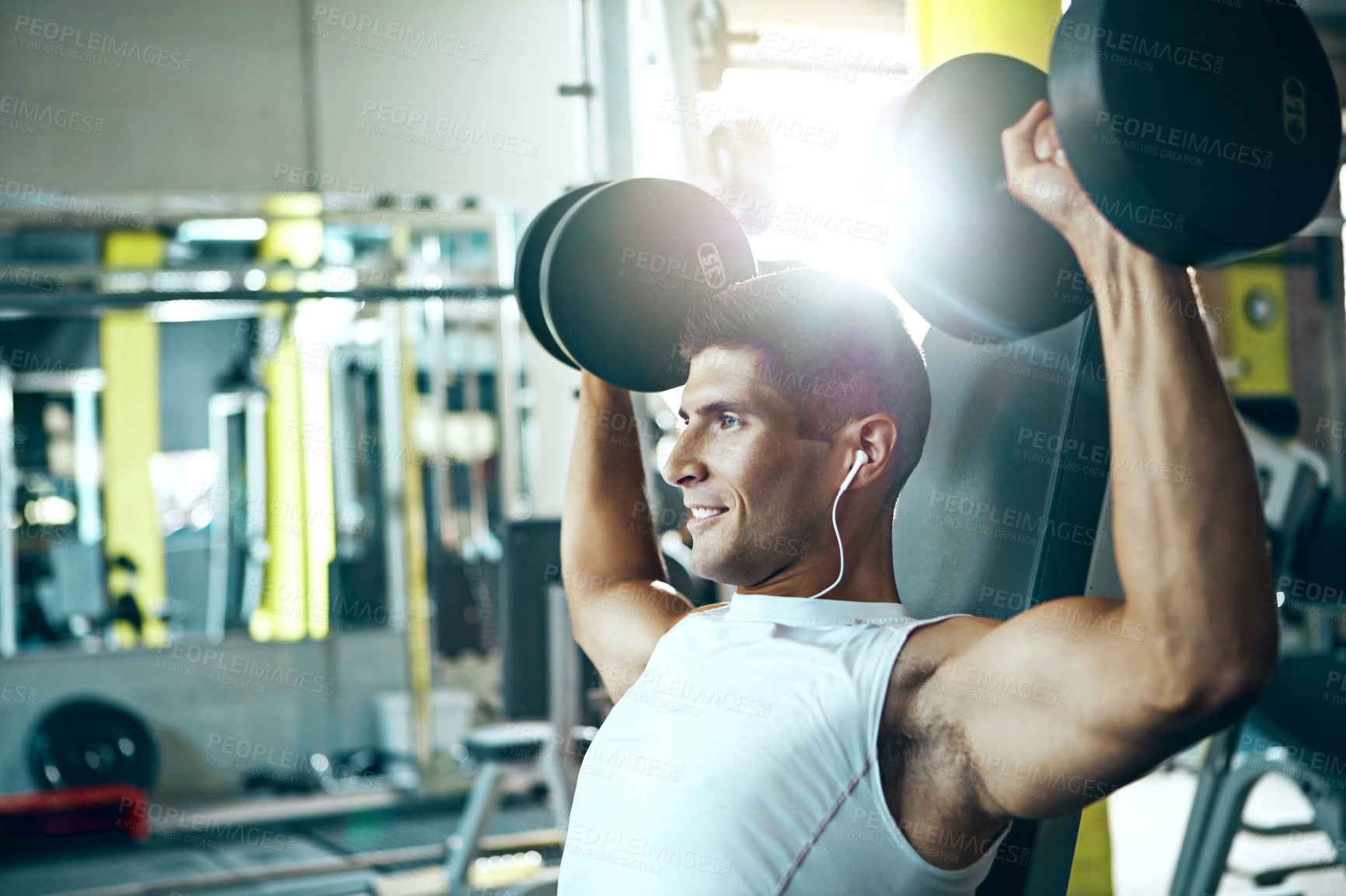 Buy stock photo Shot of a man doing a upper-body workout at the gym