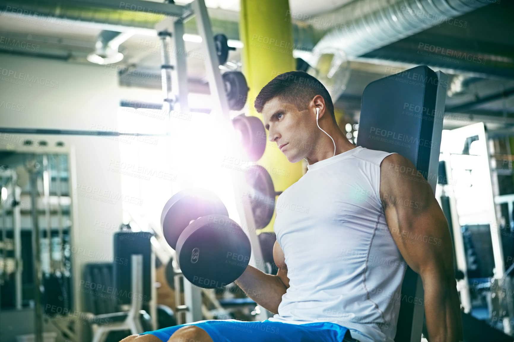 Buy stock photo Shot of a man doing a upper-body workout at the gym