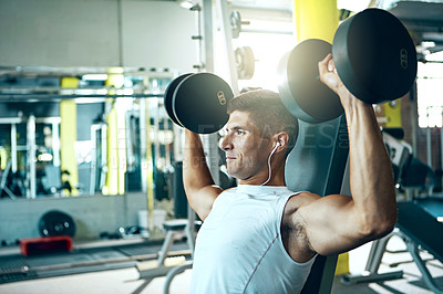 Buy stock photo Shot of a man doing a upper-body workout at the gym