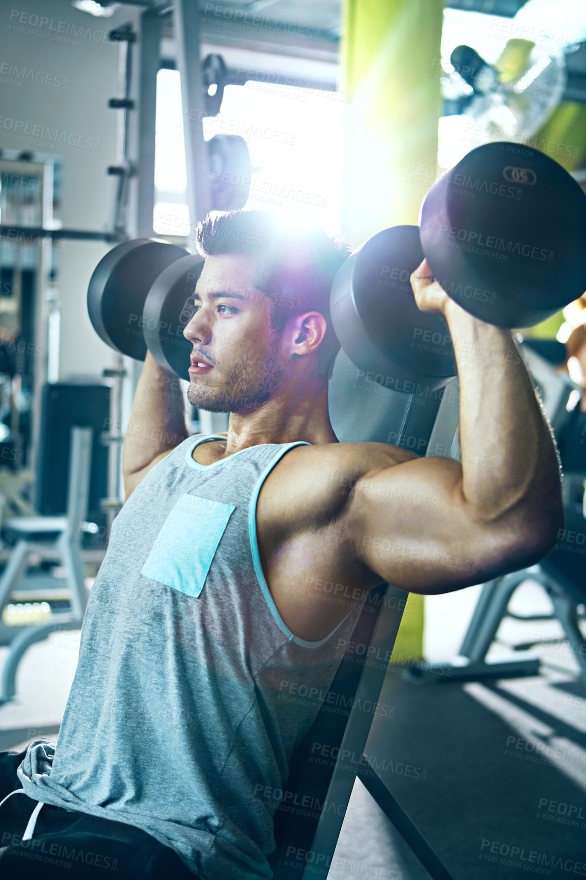 Buy stock photo Shot of a man doing a upper-body workout at the gym