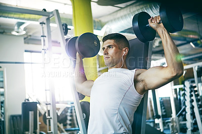 Buy stock photo Shot of a man doing a upper-body workout at the gym